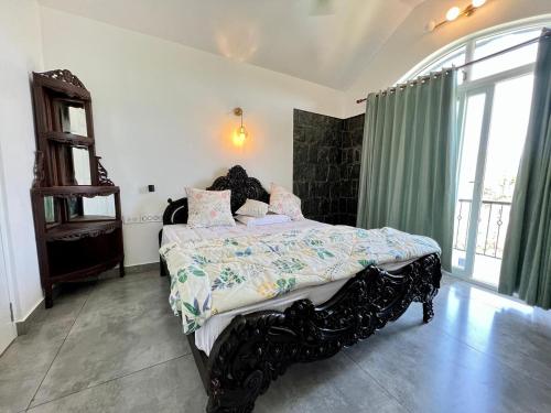 a bedroom with a large bed in a room at The Heyday in Vagamon