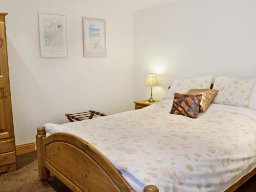 a bedroom with a bed with a pillow on it at Owl Cottage - E4092 in Jevington