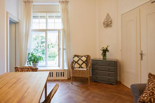 a living room with a table and a window at Schloss Mörlbach in Icking