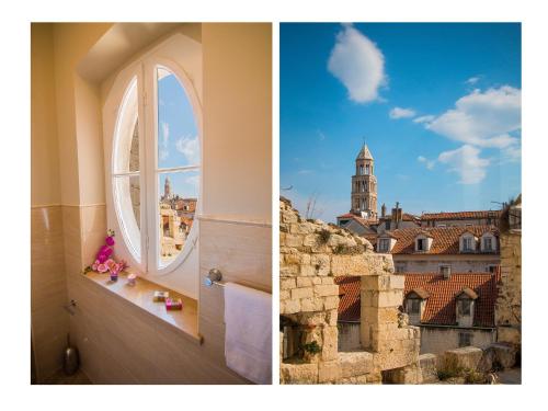 a bathroom with a window and a view of a city at Riva Royal View Luxury Apartments in Split