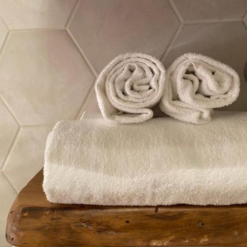 a pile of white towels sitting on a cutting board at LaLucia Luxury Suite Lake Como in Argegno