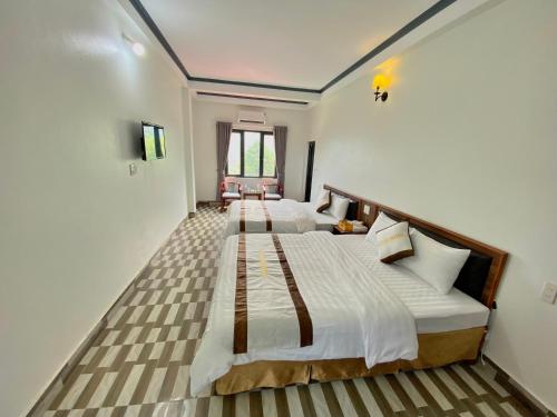 een grote slaapkamer met 2 bedden bij An Thảo Ba Bể Hotel in Ba Be18