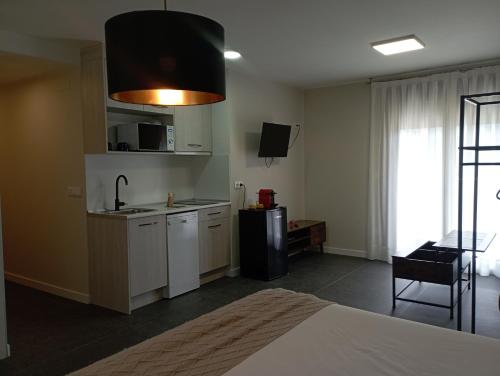 a kitchen with white cabinets and a sink in a room at Mirador de Chisten in Gistaín