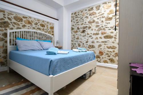 Kroústas的住宿－Konstantis，石墙客房的卧室配有一张床