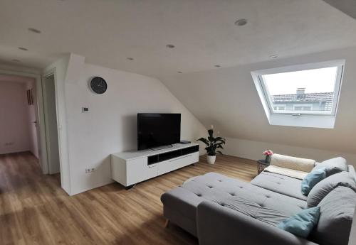 a living room with a couch and a flat screen tv at Ferienwohnung Rein in Oberteuringen