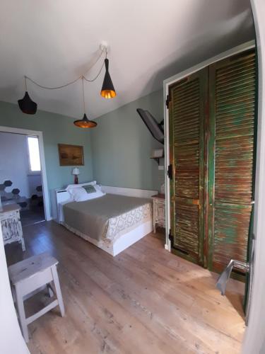 a bedroom with a bed and a wooden floor at Helix 1912 in Bric Gallo