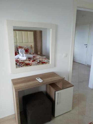 a room with a table with a mirror on the wall at Apartments Alsa in Ulcinj