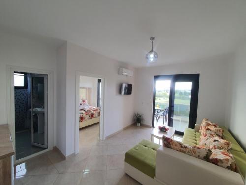 a living room with a couch and a bedroom at Apartments Alsa in Ulcinj