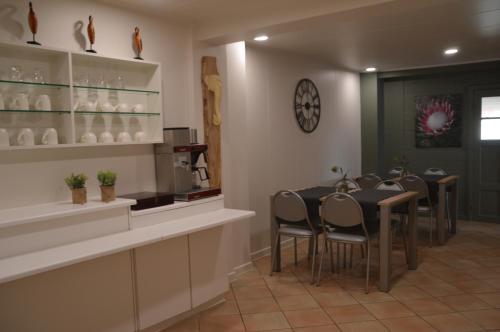 una sala da pranzo con tavolo e sedie di B&B The Protea a Zonnebeke