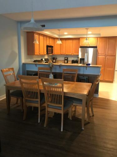 a kitchen with a wooden table and chairs and a kitchen with a counter at Beautiful Condo in Ocean City