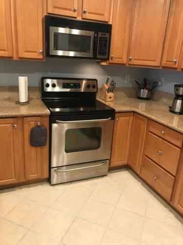 a kitchen with a stainless steel oven and a microwave at Beautiful Condo in Ocean City