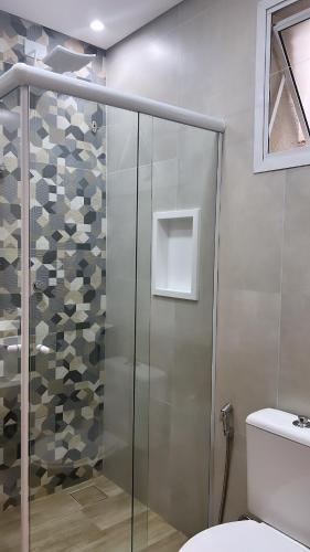 a shower with a glass door in a bathroom at Hotel Rio in Guarujá