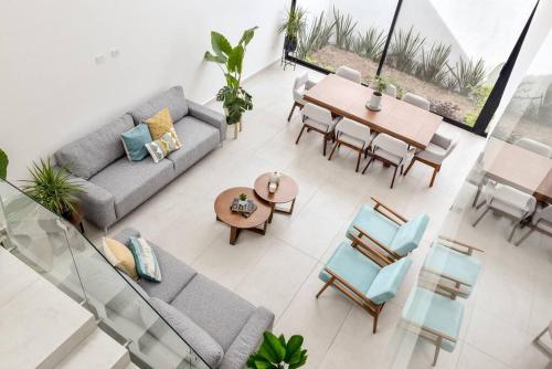 a living room with a couch and a table and chairs at Casa con Vista al Cielo in Aguascalientes