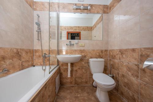 a bathroom with a toilet and a sink and a shower at Hotel Hrabovo in Ružomberok