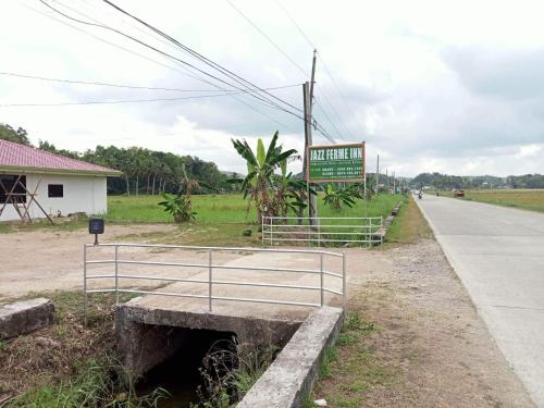 a sign on the side of a road at Jazz Ferme Inn Batuan Bohol in Batuan