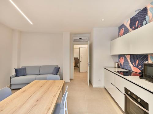 a kitchen and living room with a table and a couch at ApartmentsArena - Residenza Dei Doganieri - Verona in Verona