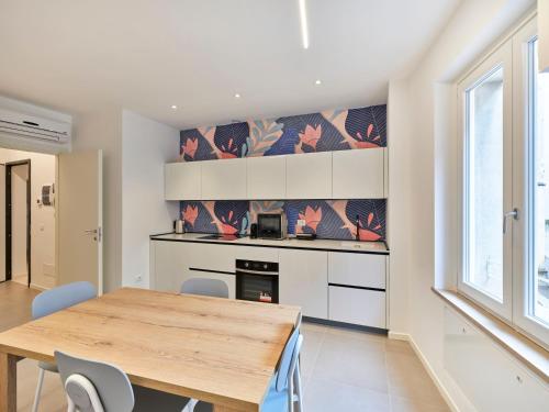 a kitchen with a wooden table and a dining room at ApartmentsArena - Residenza Dei Doganieri - Verona in Verona