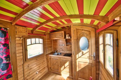 an interior view of a kitchen with a colorful ceiling at Clamador in Saintes-Maries-de-la-Mer