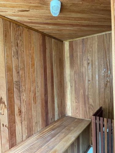 a wooden wall of a sauna with a light on it at Pousada Renovo da Serra in São Pedro da Serra