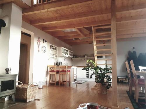 a living room with a loft bed and a table at Tranquil cottage in Banská Štiavnica mountain in Uhliská