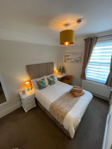 a bedroom with a large bed and a window at Rivendell Guest House in Swanage