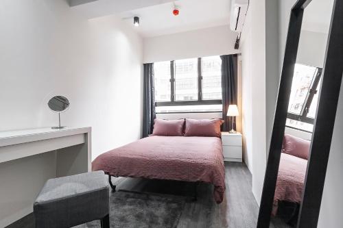 a small bedroom with a bed and a fireplace at Les Barons in Hong Kong