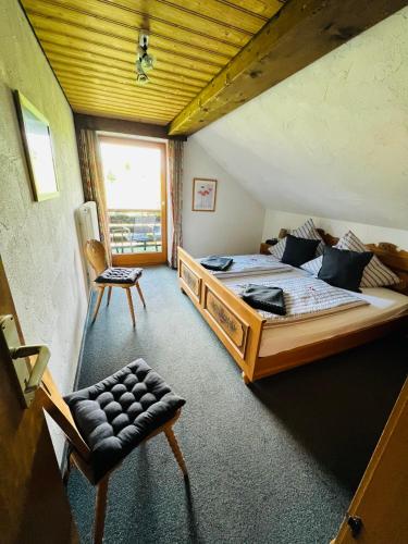 a bedroom with a large bed with a wooden ceiling at Ferienwohnungen Britta Heim in Oberstaufen