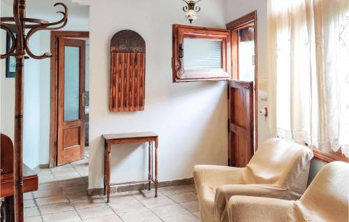 a living room with a couch and chairs and a window at Cozy Home In Baza With Wifi in Baza