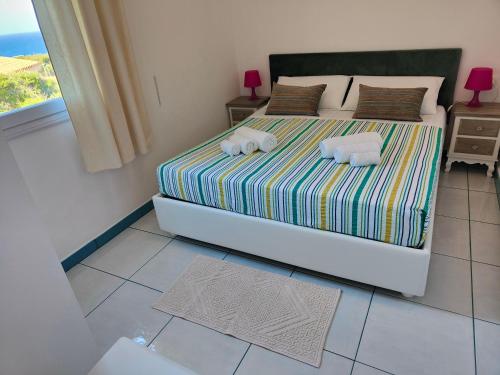 a bedroom with a bed with towels on it at Casa Vacanze Miranda in Torre Dei Corsari