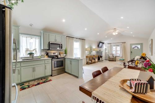 a kitchen with green cabinets and a table in a room at Tulsa Vacation Home about 3 Mi to Downtown in Tulsa