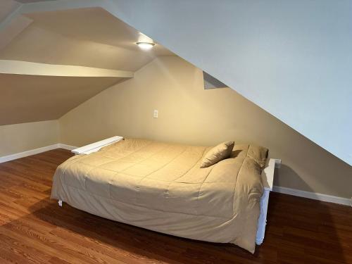 a bedroom with a bed in a attic at Forest and River Side Tranquil House in Montague