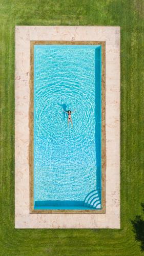 a person in the water with a surfboard at Tenuta le Viste - panoramic Villa in Scandicci