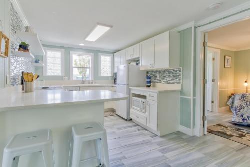a kitchen with a white counter and stools in it at Pirates Pointe Resort in Ruskin