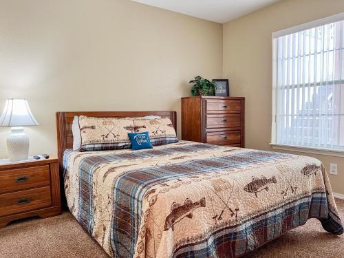 a bedroom with a bed and a dresser and a window at Lake Front 2BR Walk-In with Large Deck - FREE TICKETS INCLUDED - 79-1 in Branson