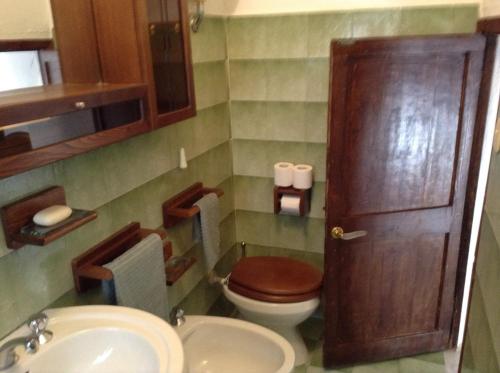 a small bathroom with a toilet and a sink at Casa SILVIO in Sesta Godano