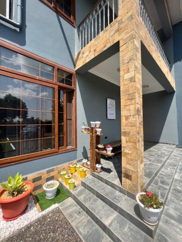 a patio with some plants and a building at Lerai Homes in Arusha