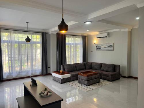 a living room with a couch and a table at Lerai Homes in Arusha