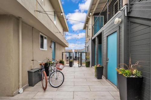 a bike parked on a sidewalk between two buildings at Tower 9 #1 in Oceanside