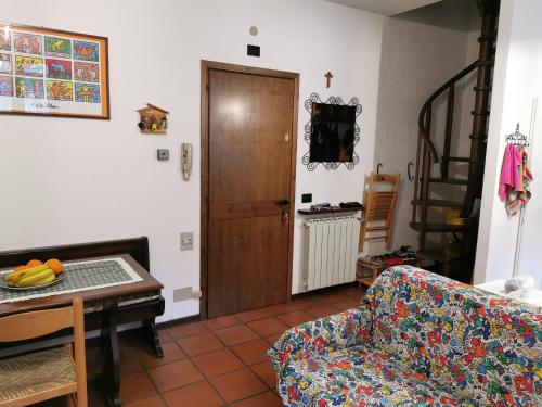 a living room with a couch and a table at Appartamento Alba - Residence Montesole in Ponte di Legno