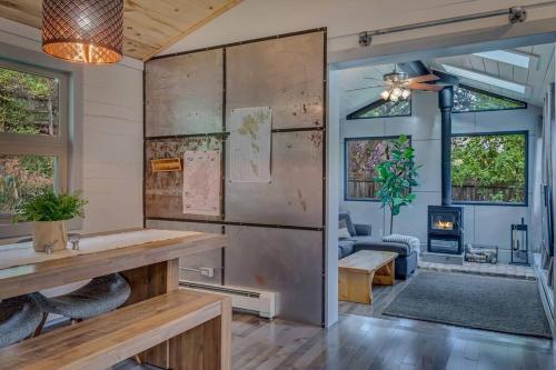 a living room with a table and a fireplace at Cozy Modern House seconds from Roaring Fork River in Glenwood Springs