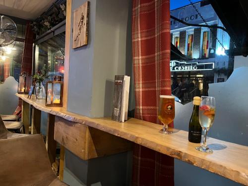 a bar with two glasses of beer on a counter at Whitstable The Jolly in Whitstable