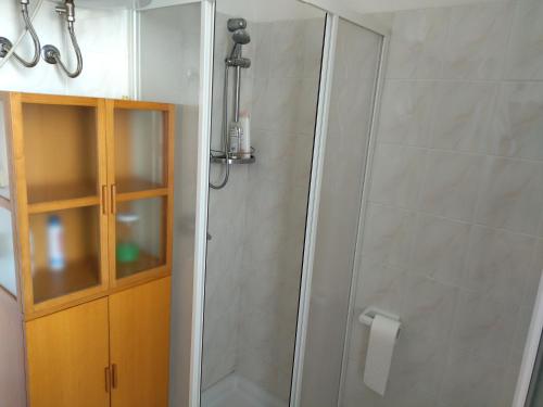 a bathroom with a shower with a glass door at Casa vacanze Elisio in Torre dell'Orso