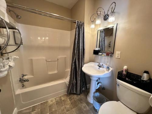 a bathroom with a sink and a toilet and a shower at Historic Branson Hotel - Haven Suite with Queen Bed - Downtown - FREE TICKETS INCLUDED in Branson