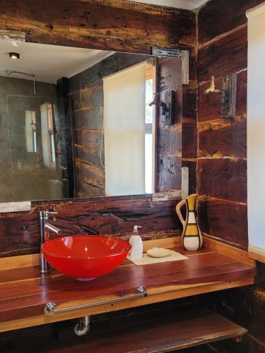 a bathroom with a red sink and a mirror at La Comarca in San Javier