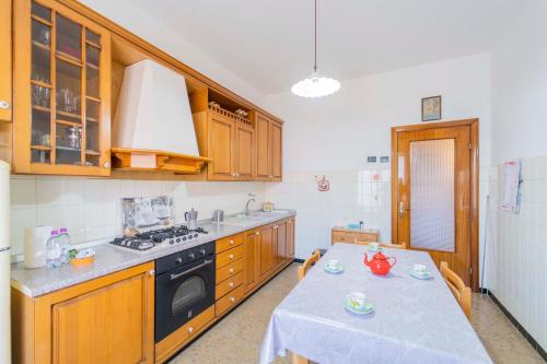 uma cozinha com uma mesa e um fogão em 104 - Casa Tulipano Riva Trigoso, a due passi dal mare - Posto auto privato gratis em Riva Trigoso