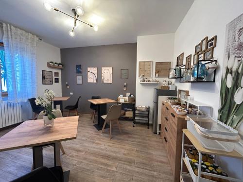 a living room with tables and a dining room at B&B Sirolo My House in Sirolo