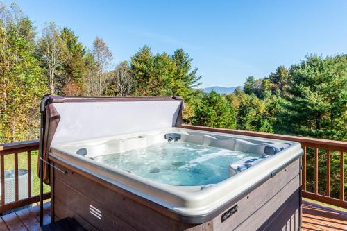 a hot tub on a deck with trees at Villa at Stony Woods Estate mountain luxury near Asheville in Marshall