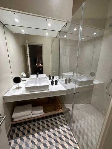 a bathroom with a sink and a mirror at Downtown collection apartments in Funchal