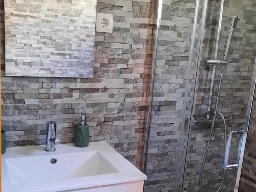 a bathroom with a sink and a shower at Quinta do Iteiro in Cova