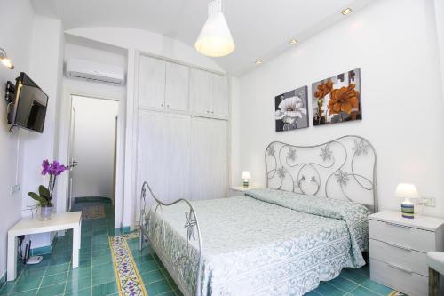 a bedroom with a bed and a television in it at Via Col Vento in Ravello